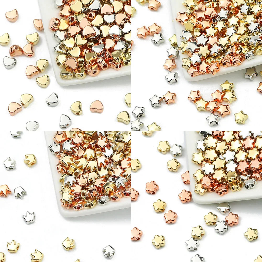 Assorted gold, silver and rose gold metallic beads in heart, star, crown and flower shapes for jewelry making