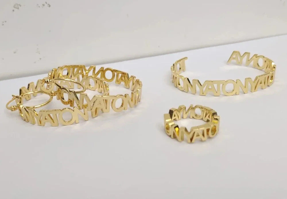 Custom gold-tone stainless steel name hoop earrings, cuff bracelet, and ring set