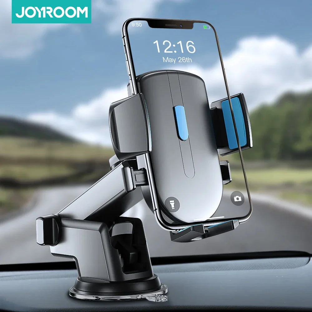 A black gravity car phone holder mounted on a dashboard, holding a smartphone.
