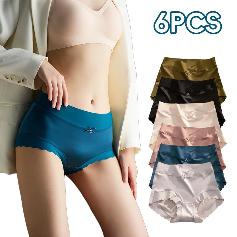 A woman in a white blazer and blue satin panties with a display of six colored pairs.