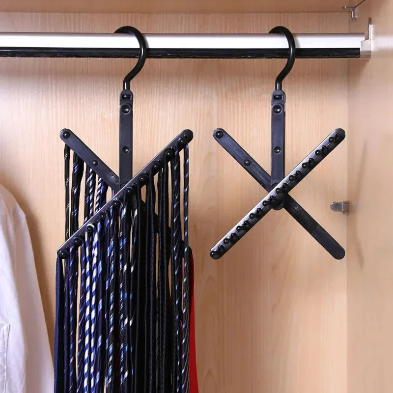 A black tie organizer hanger fully unfolded, holding multiple men's neckties in a closet.
