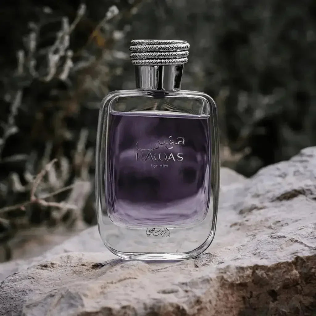 Bottle of purple men's eau de parfum resting on a textured rock surface