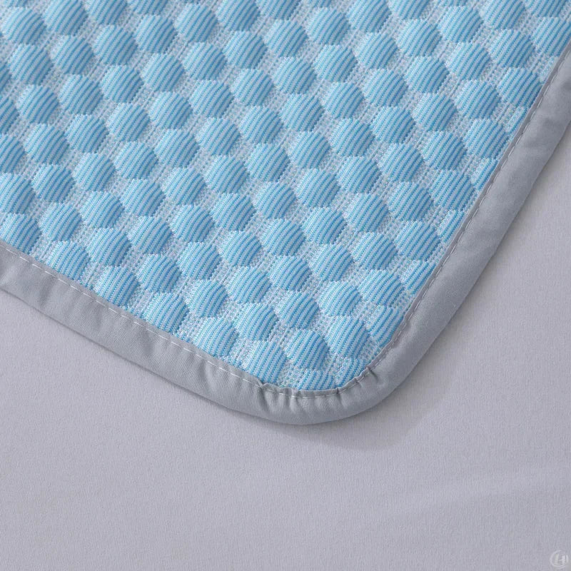 Corner of blue and white honeycomb pillowcase with grey piping