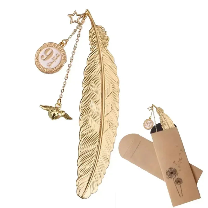 Golden metal feather bookmark with platform 9 3/4 charm and snitch pendant in a decorative paper sleeve