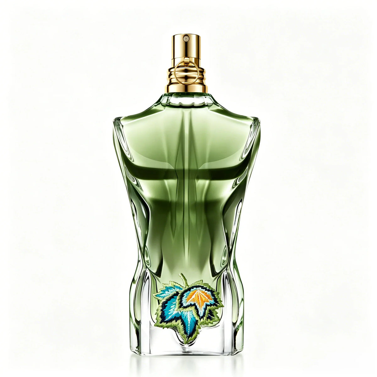Green torso-shaped glass perfume bottle featuring detailed embroidered leaves on the front.