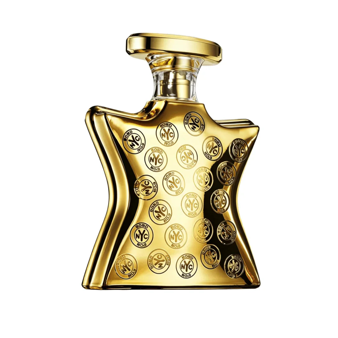 A golden perfume bottle with a star-shaped base and circular embossed details