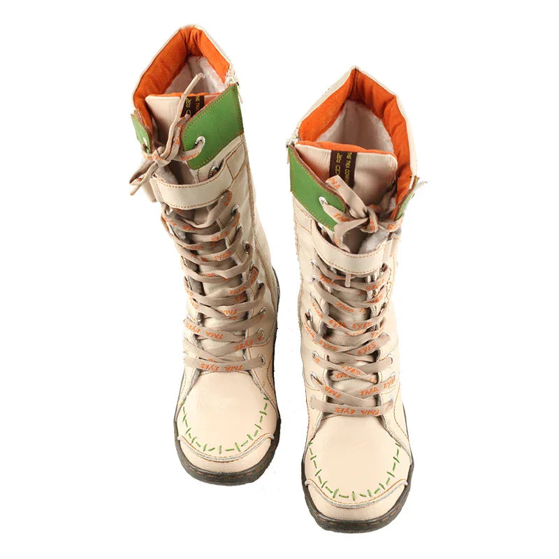 Pair of beige mid-calf lace-up boots with green trim viewed from the top