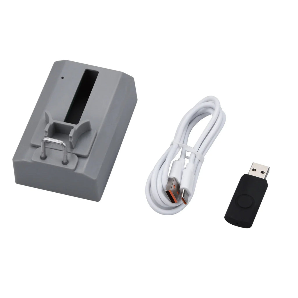 Watch repair testing equipment including grey device, white USB cord and black connector