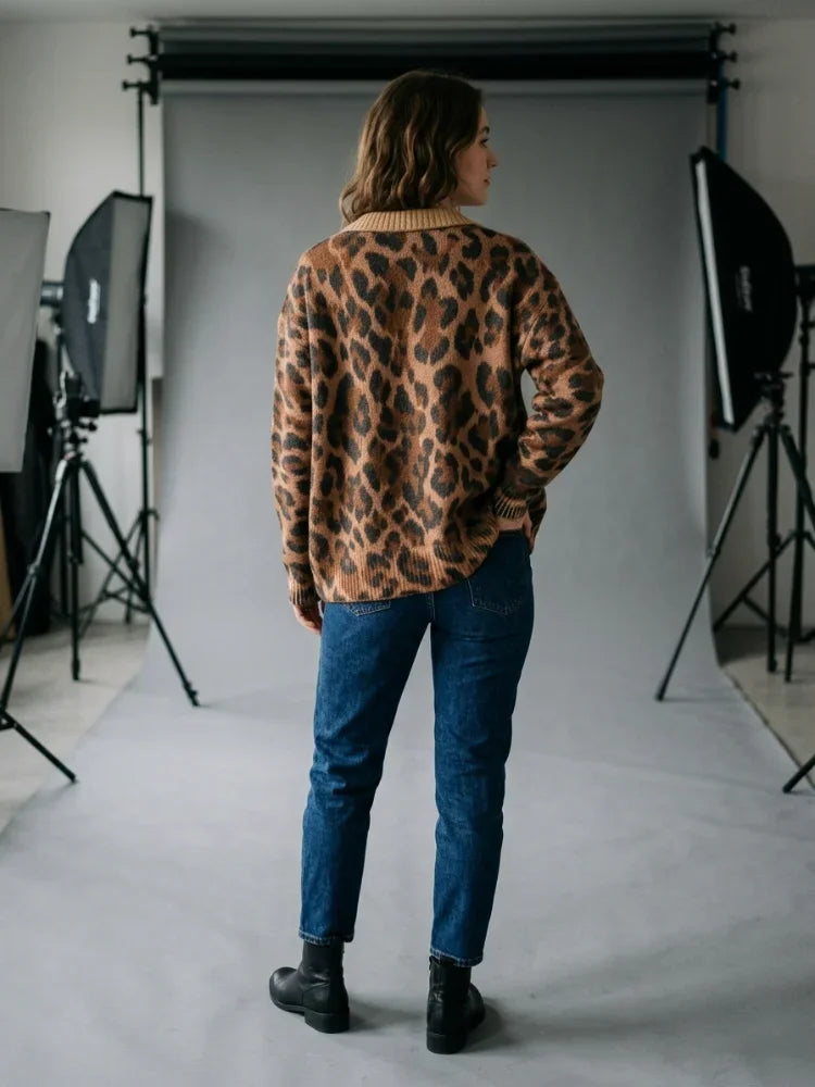 Back view of a woman wearing a leopard print cardigan in a photography studio setting