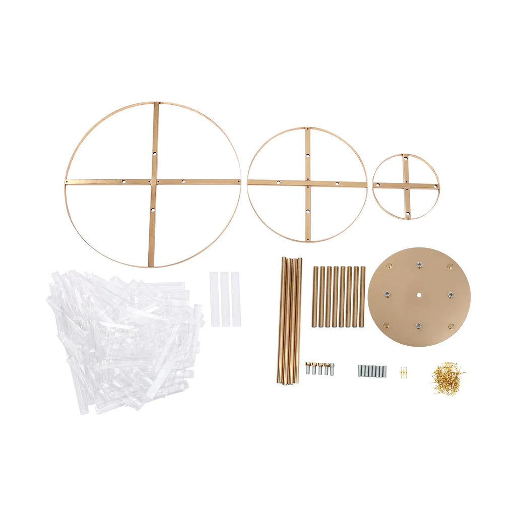 Unassembled metal gold stand parts and acrylic crystal prisms for a wedding centerpiece.