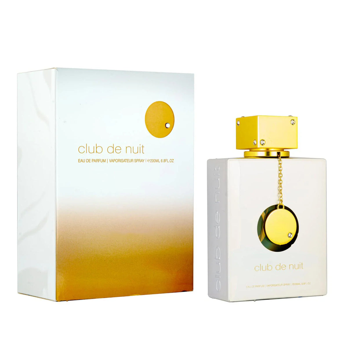 A white glass perfume bottle with a gold cap and charm, shown with its corresponding box.