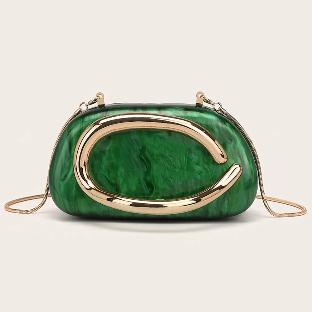 A green marble-effect evening clutch with a gold-tone metallic oval ornament and a thin chain shoulder strap.