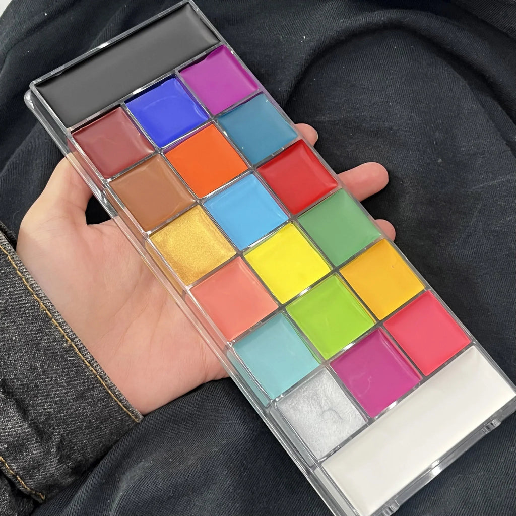 A professional multi-color face and body paint palette held in a hand
