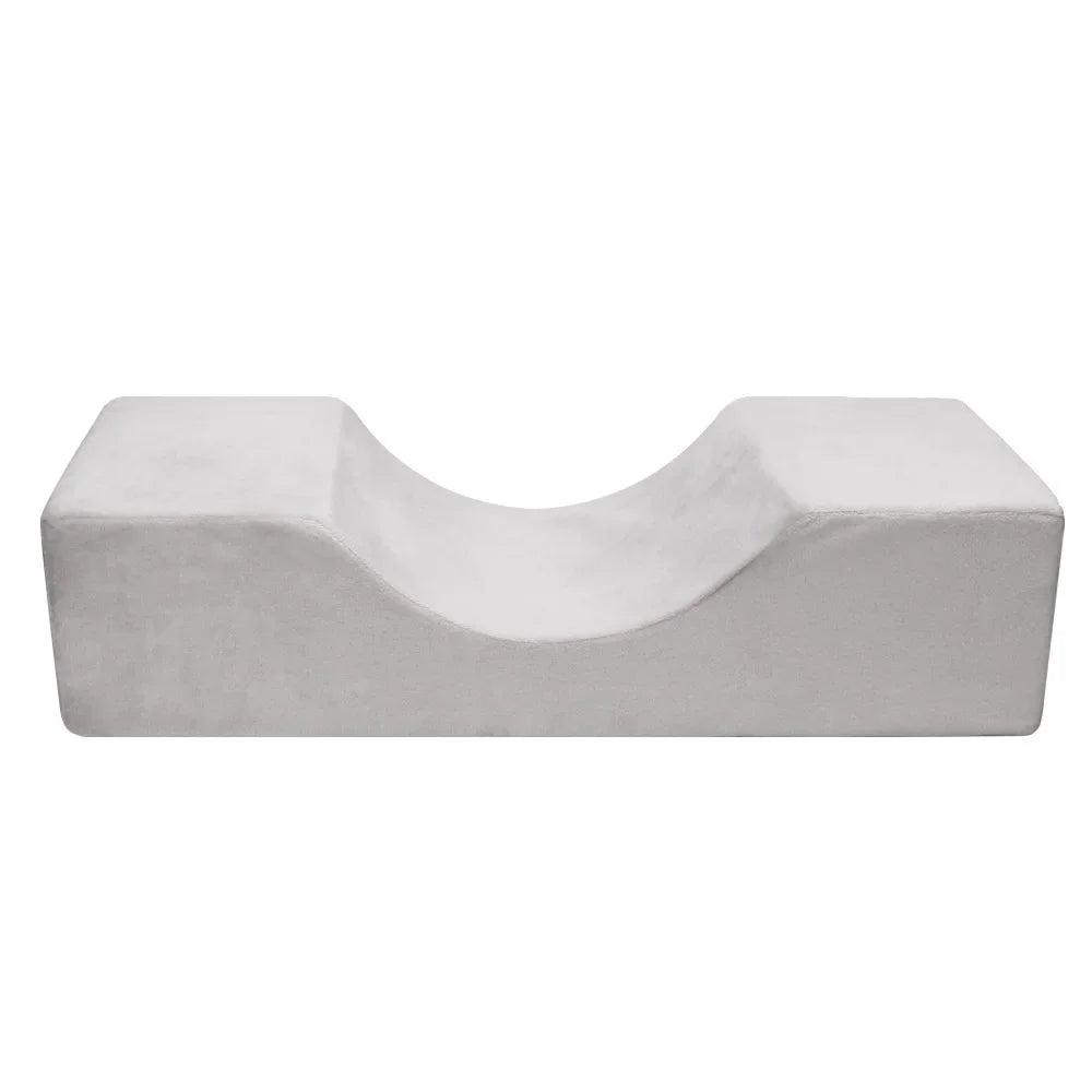 White U-shaped memory foam ergonomic neck pillow for professional eyelash extension services