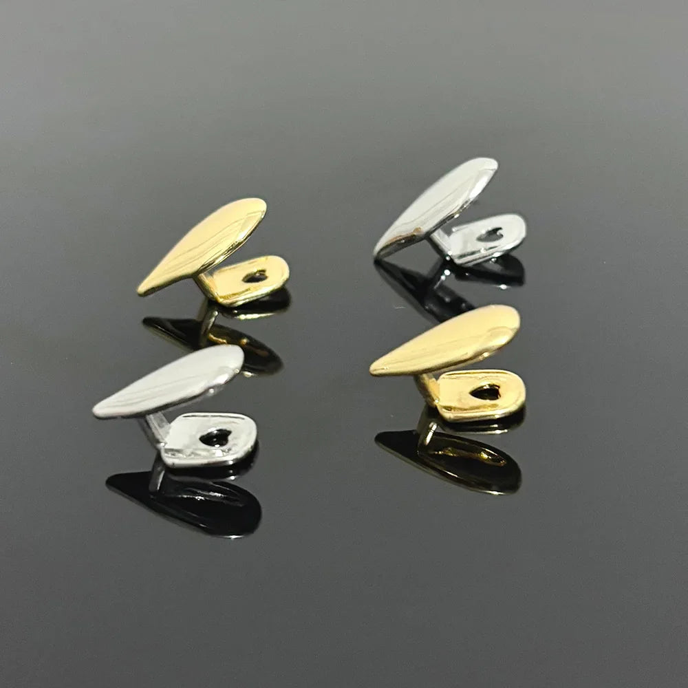 Multiple gold and silver individual vampire fang tooth grillz viewed from the side