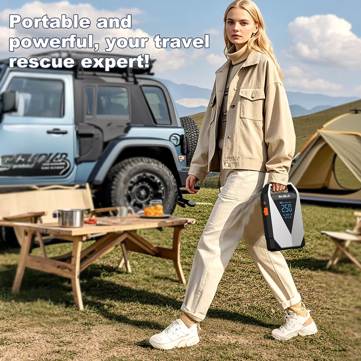 Person carrying a portable car jump starter outdoors in a camping setting