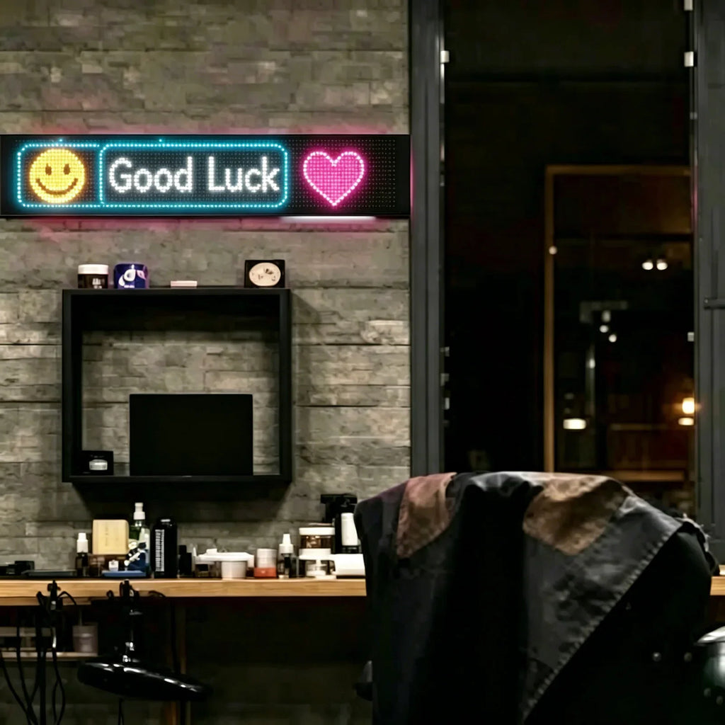 Flexible LED display mounted on a brick wall displaying a smiley face, text and a heart icon