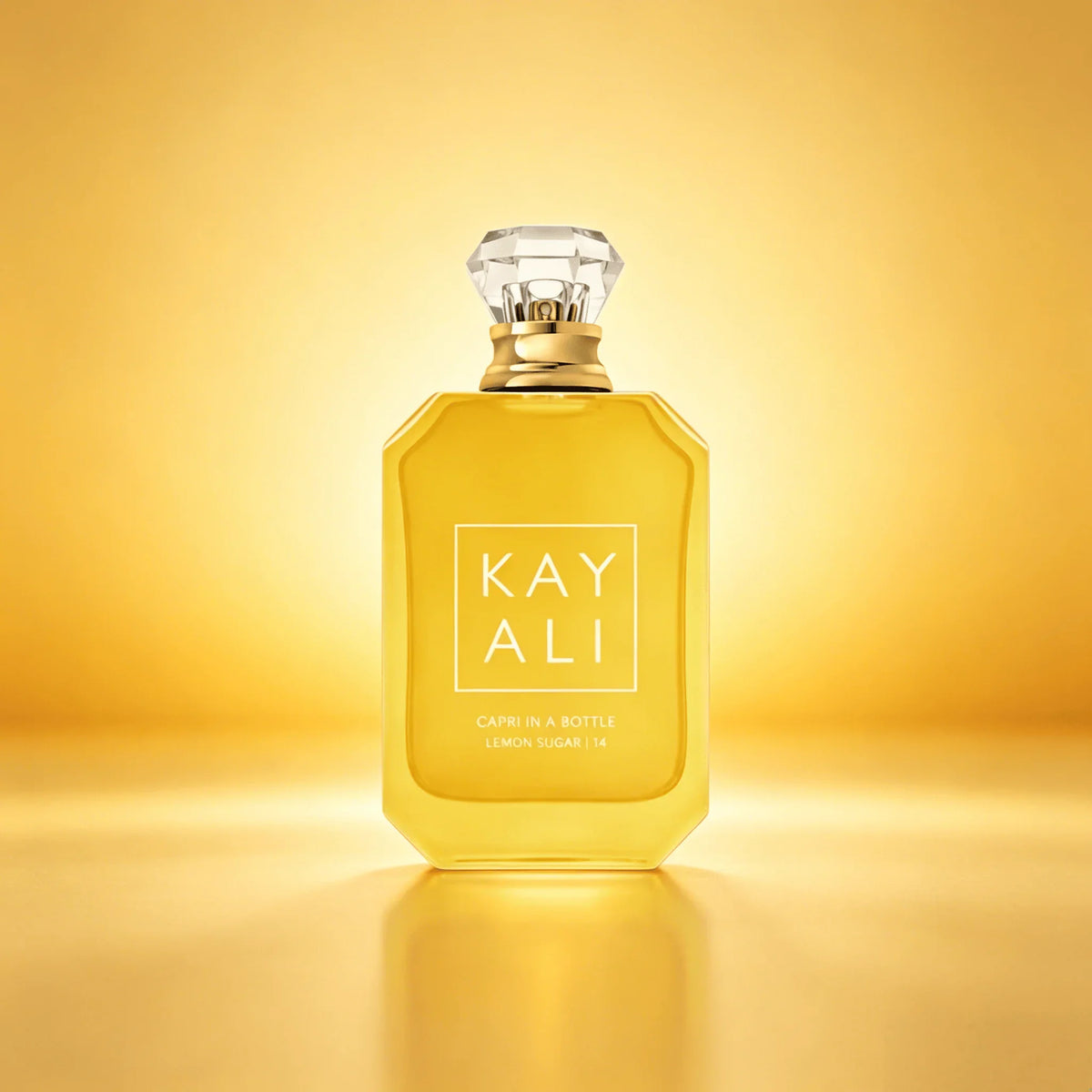 Bottle of lemon sugar scented perfume on a golden yellow background