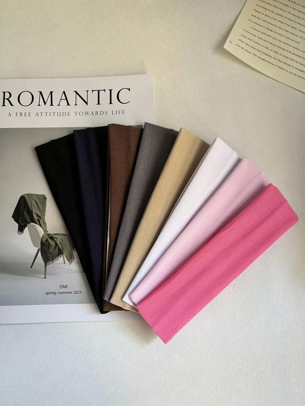 A selection of fabric headbands resting on top of a fashion magazine.
