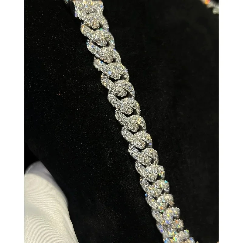Detailed view of a silver tone Cuban link chain necklace with high shine moissanite stones