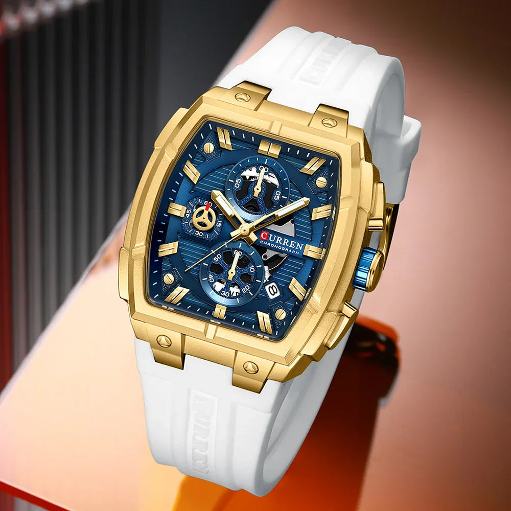 Men's square chronograph watch with gold case, blue dial, and white silicone strap
