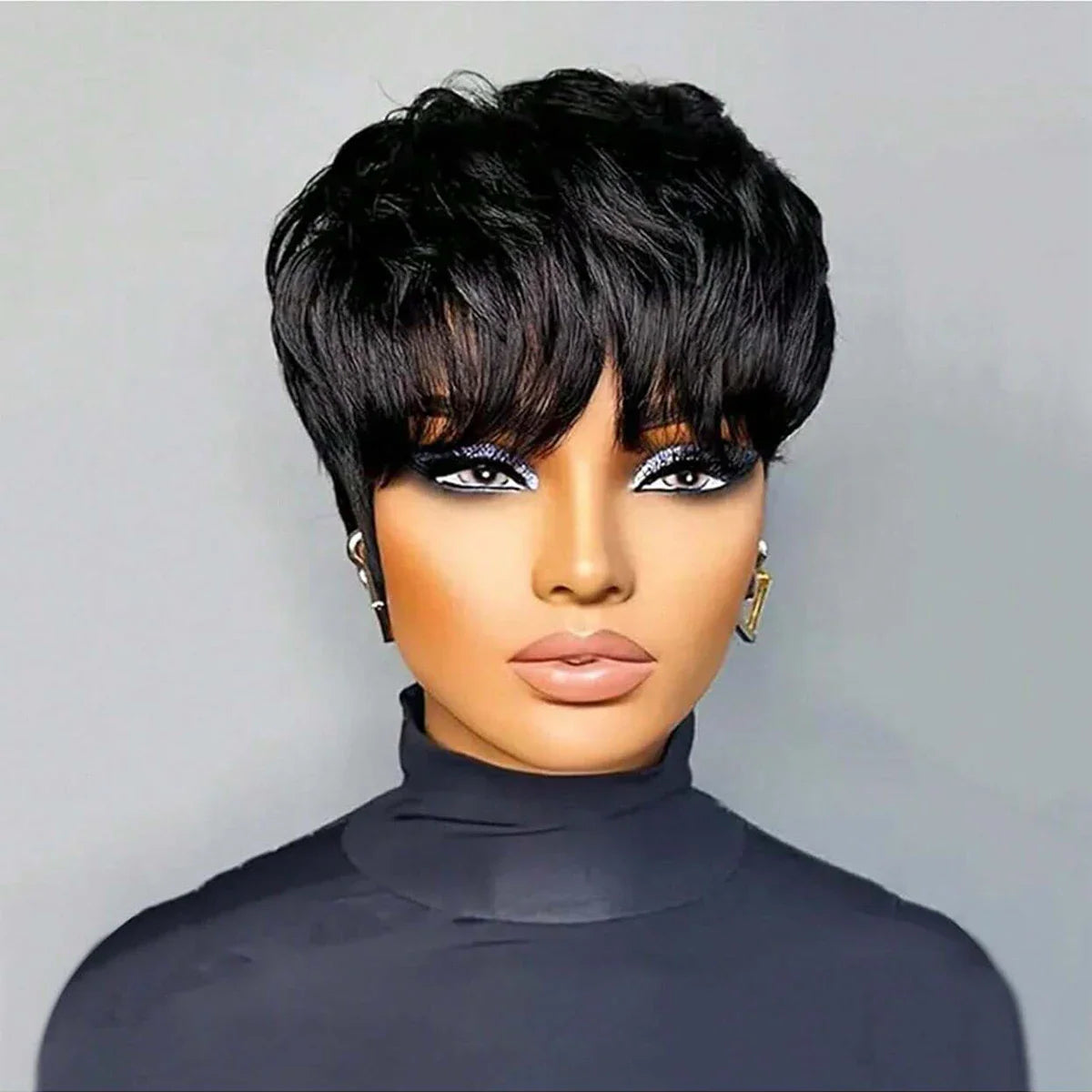 A front view of a woman with a short, layered black pixie cut wig featuring bangs.