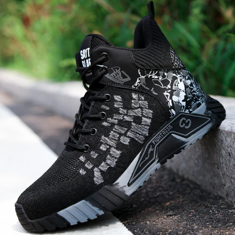 Black athletic style safety boot resting on a concrete curb