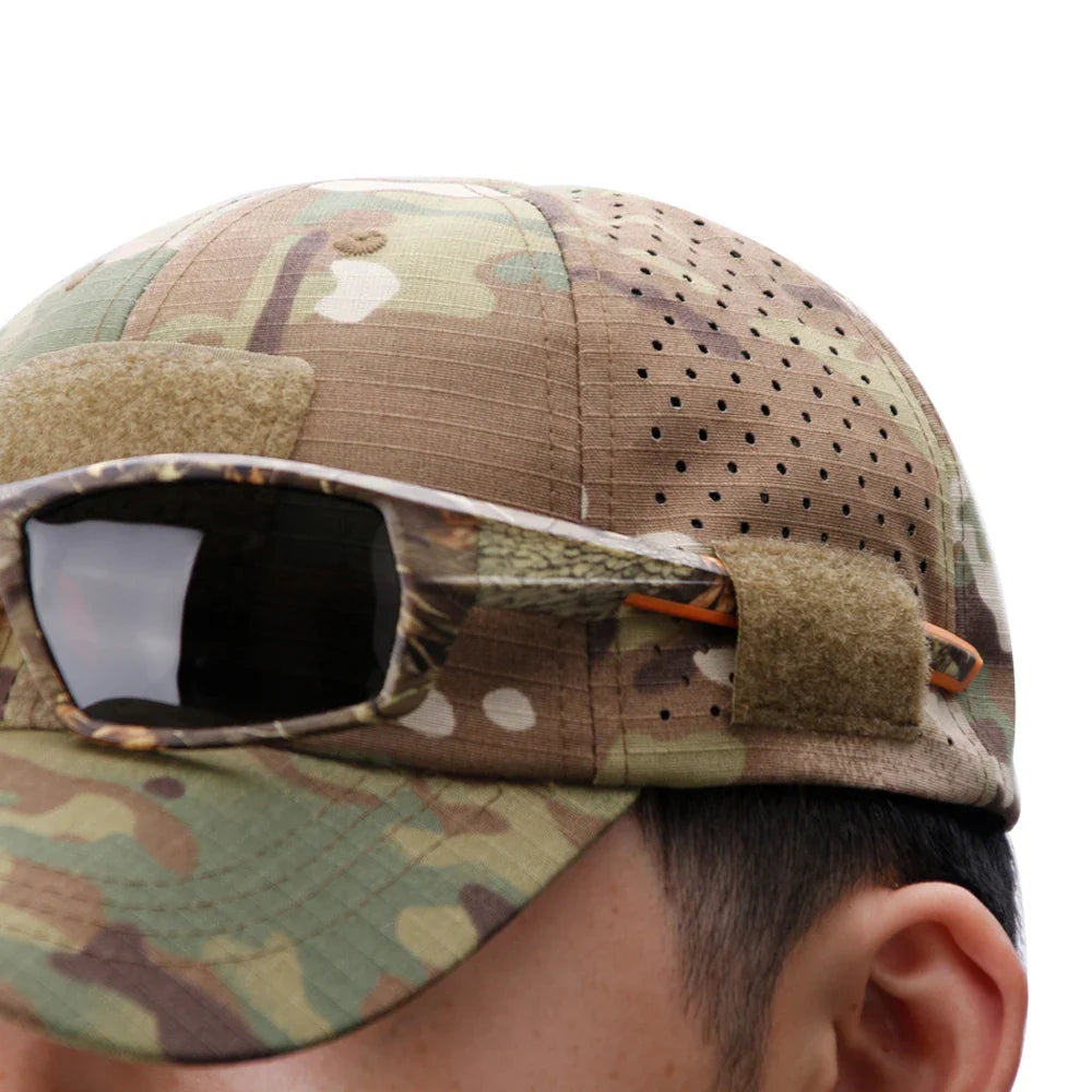 Close up of a camouflage baseball cap with sunglasses resting on the brim
