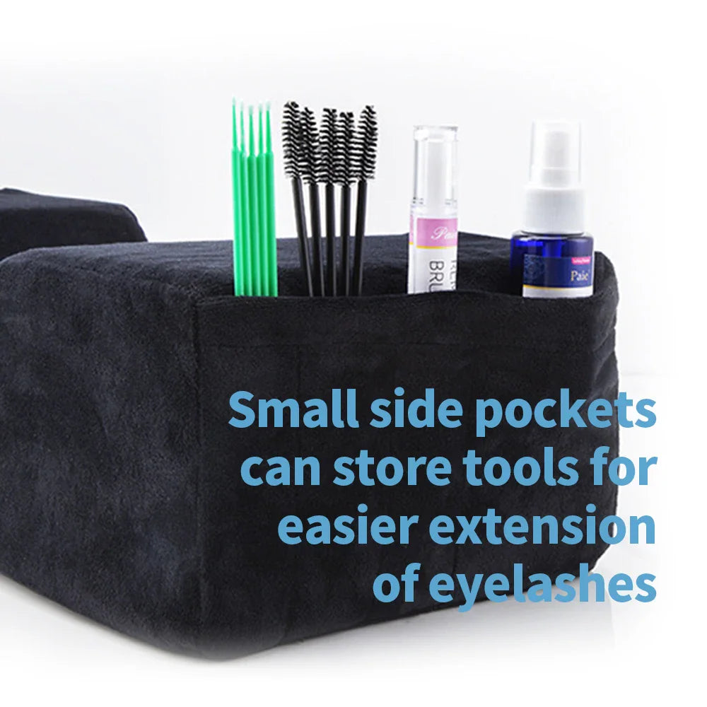 Black memory foam eyelash pillow with side pockets holding lash extension tools and supplies