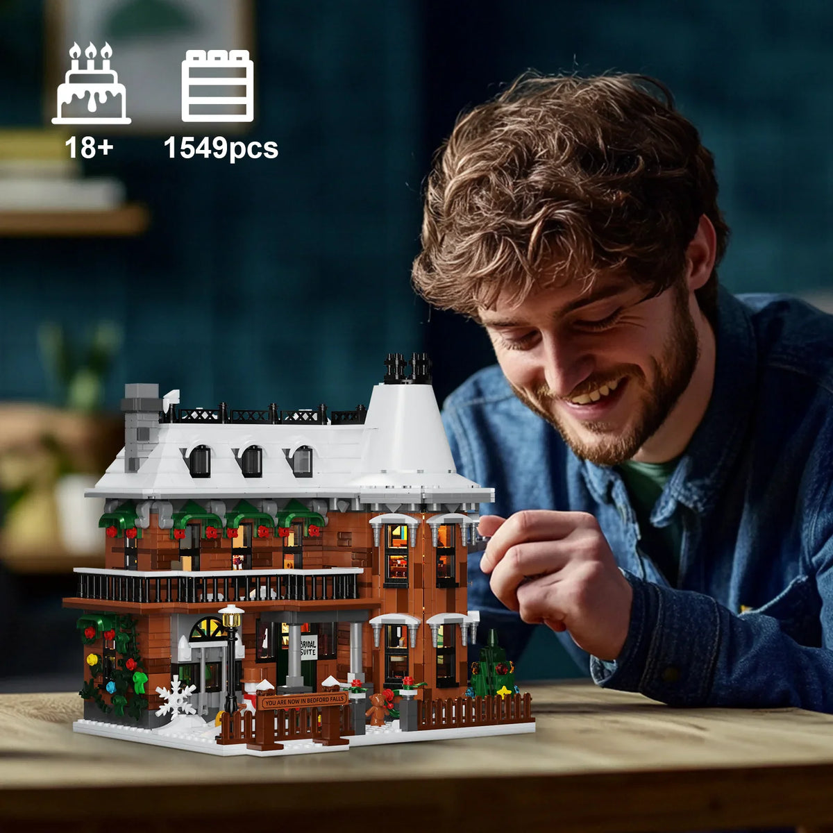 A man assembling a Christmas theme building block house model