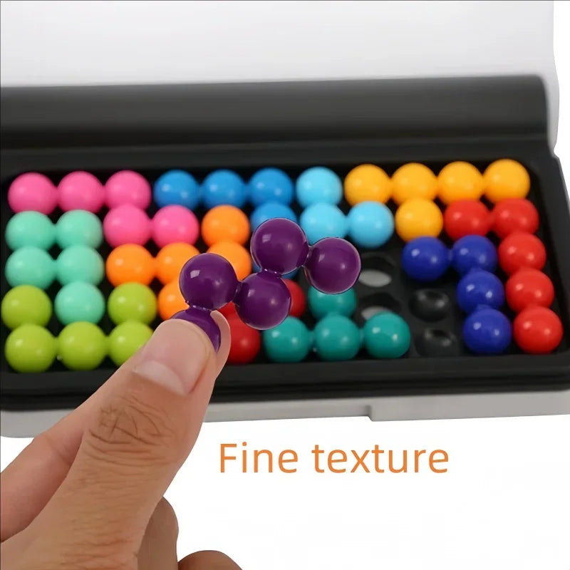 Hand holding a purple 3D puzzle piece above a game board with multicolored ball pieces
