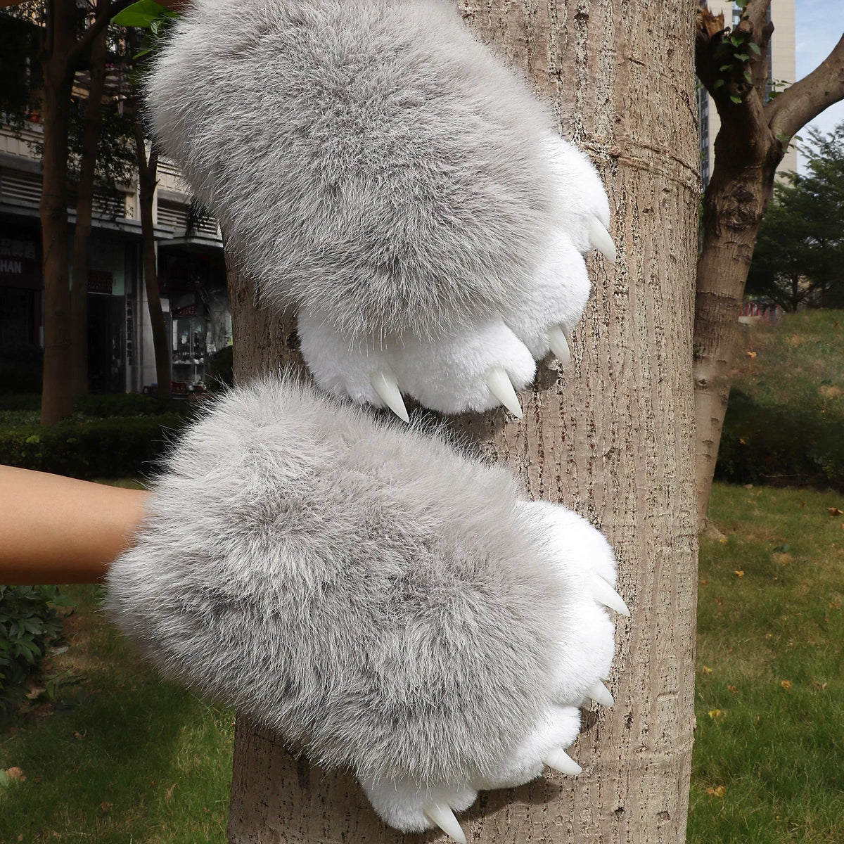Pair of gray and white plush furry animal paw gloves with claws