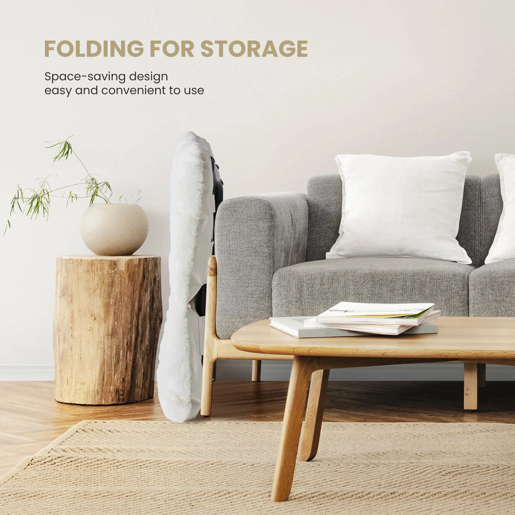 White folding saucer chair in a living room next to a couch