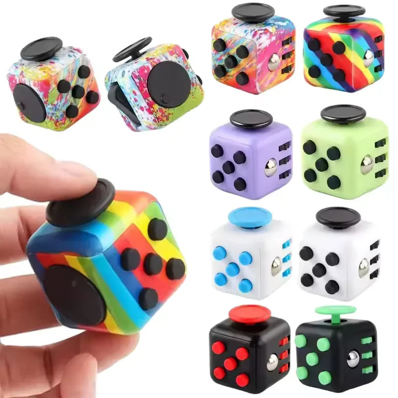 A variety of colorful sensory fidget cube toys featuring buttons, switches, and rollers in different patterns and colors.
