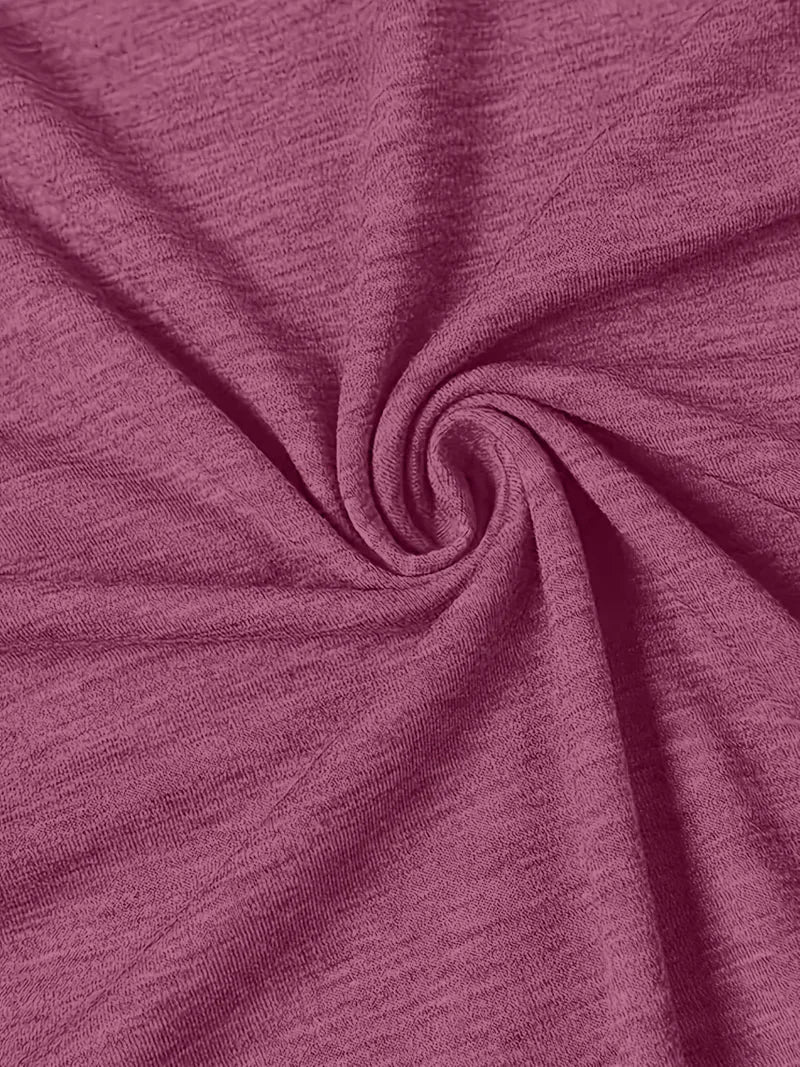 Close-up of the maroon t-shirt fabric folds and texture