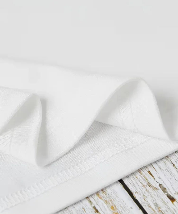 Close up of the bottom hem detail on a white t-shirt