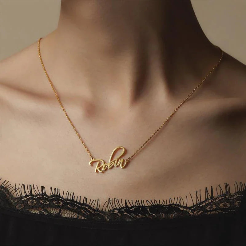Woman wearing a delicate gold custom script name necklace