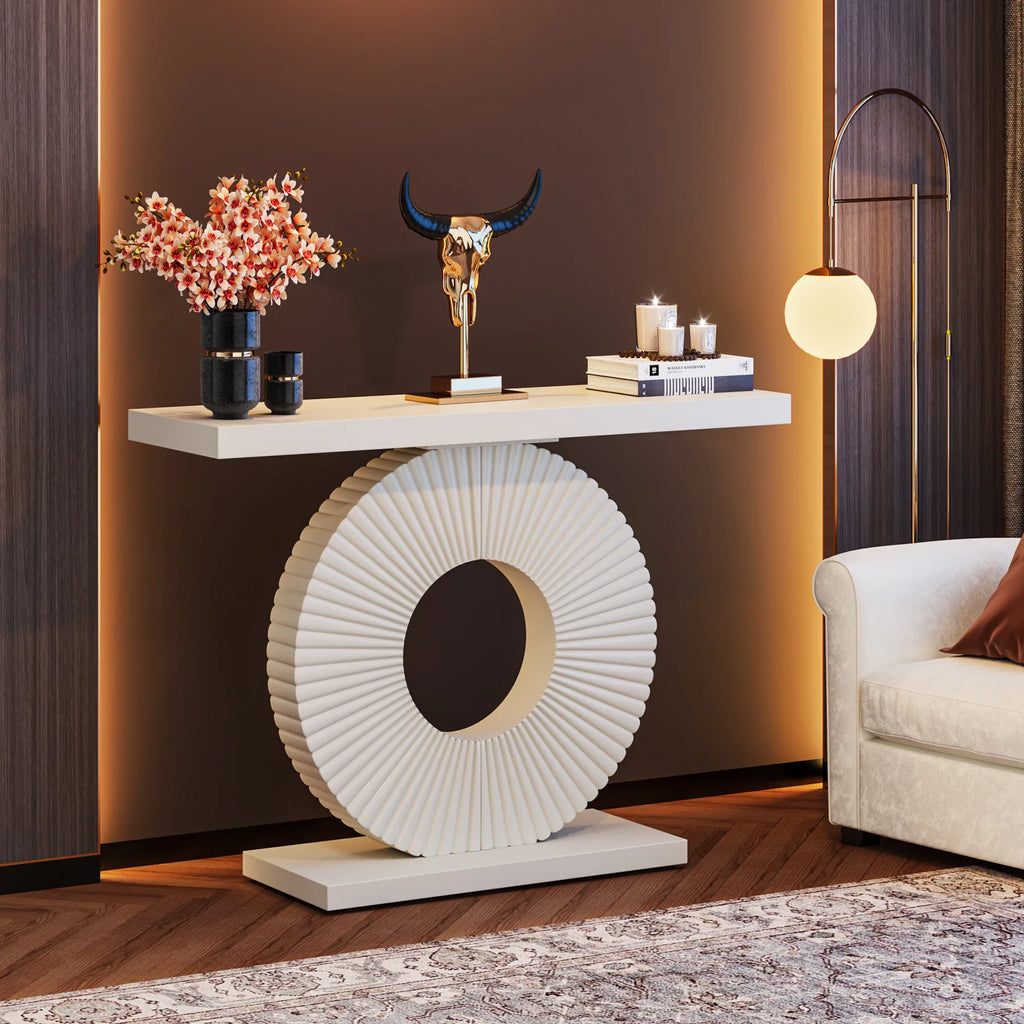 Modern white console table with a circular fluted base styled in a living room