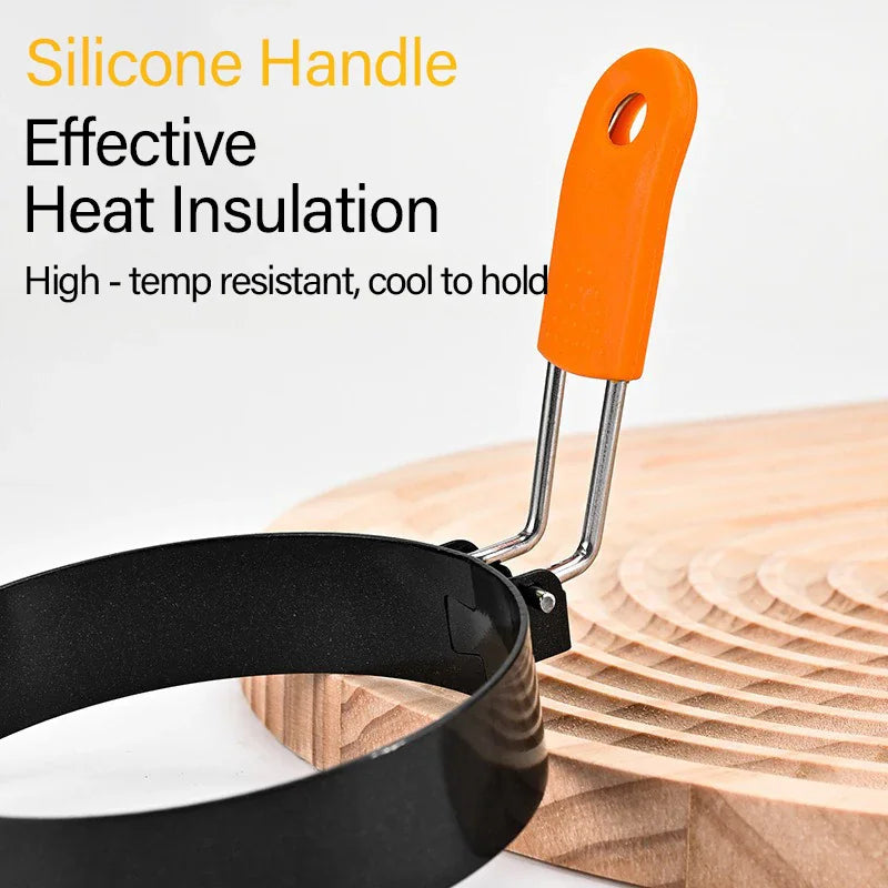 Close up view of the orange heat-resistant silicone handle on a black egg ring mold