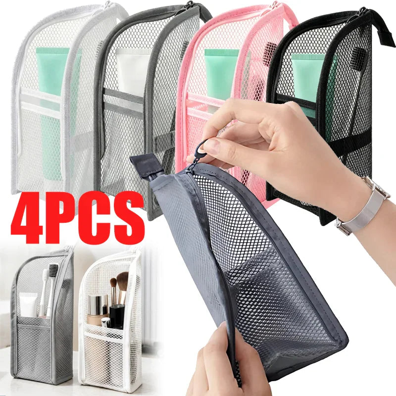 A set of four portable mesh standing toiletry bags in white, grey, pink, and black.