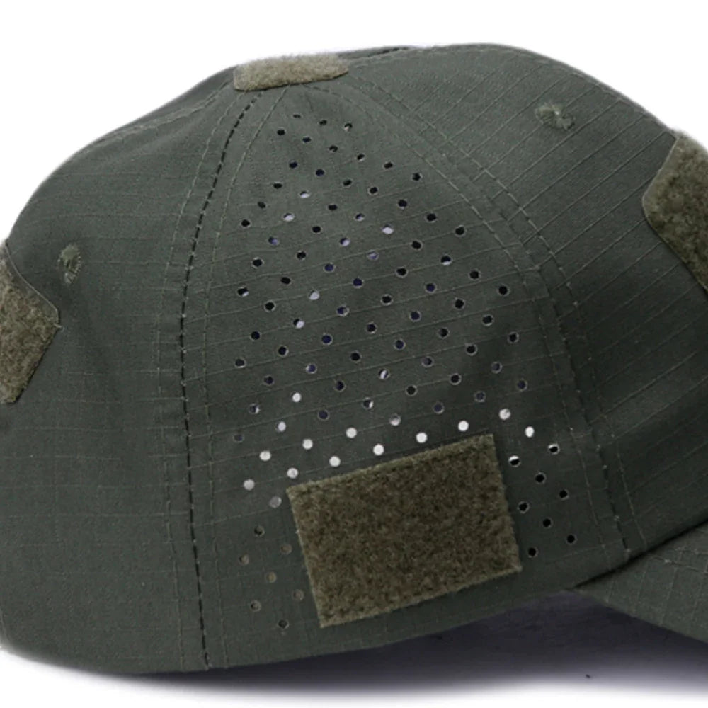 Side view of an olive green tactical baseball cap with velcro patches and ventilation holes