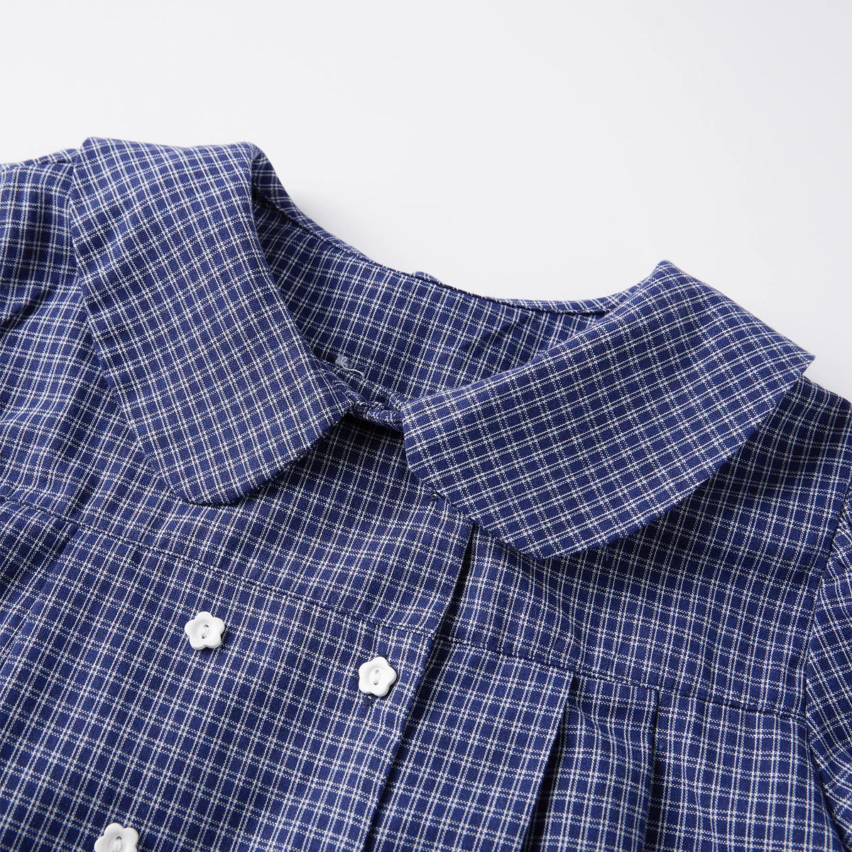 Collar and upper front detail of blue plaid short-sleeve shirt