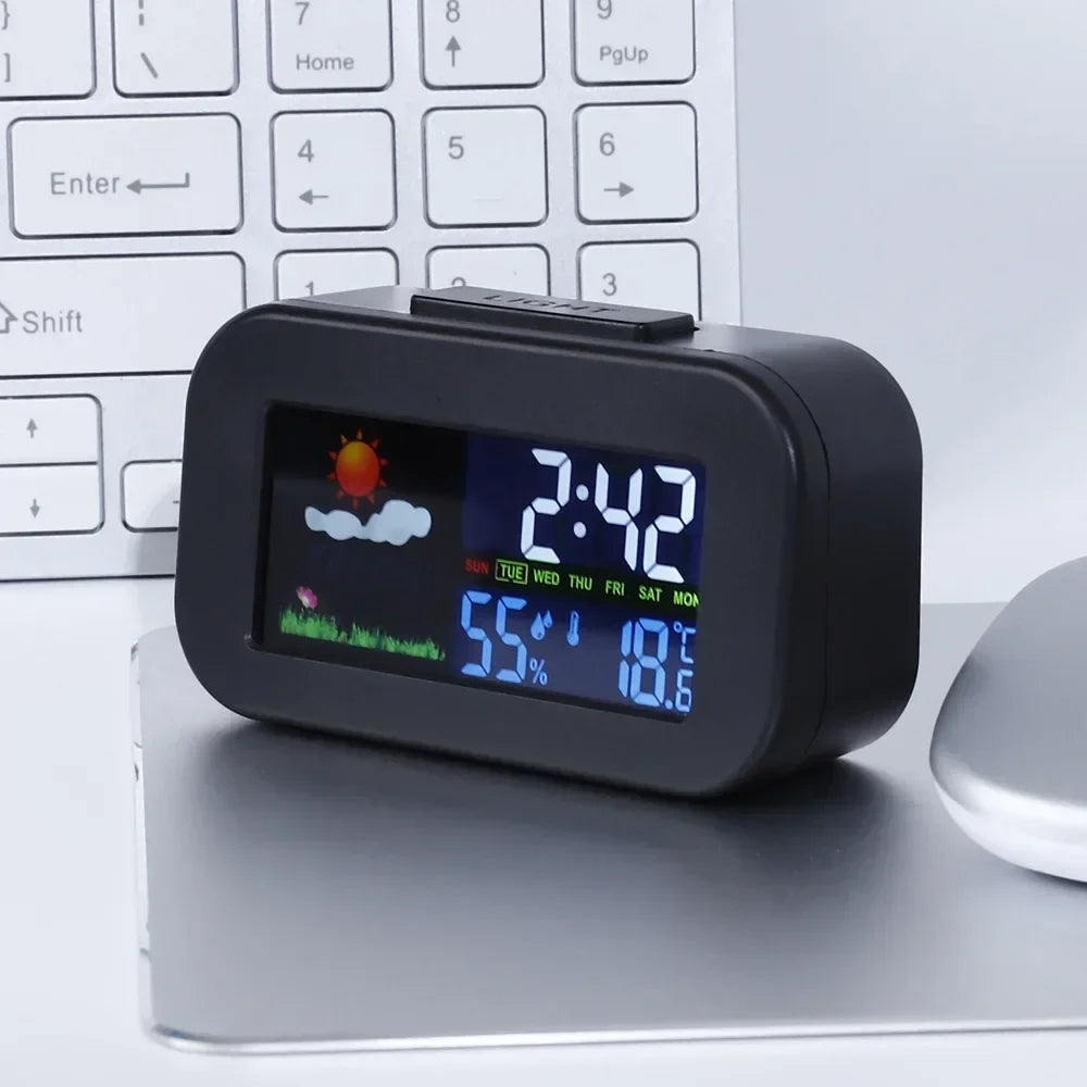 Digital alarm clock showing time, weather icon, temperature, and humidity on a black screen