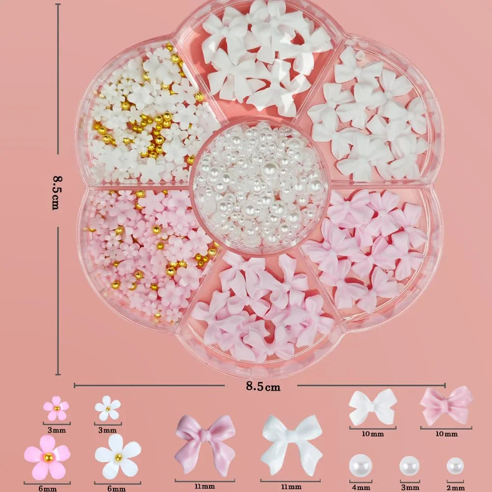 A storage container with flower, bow, and pearl nail charms on a pink background with size dimensions