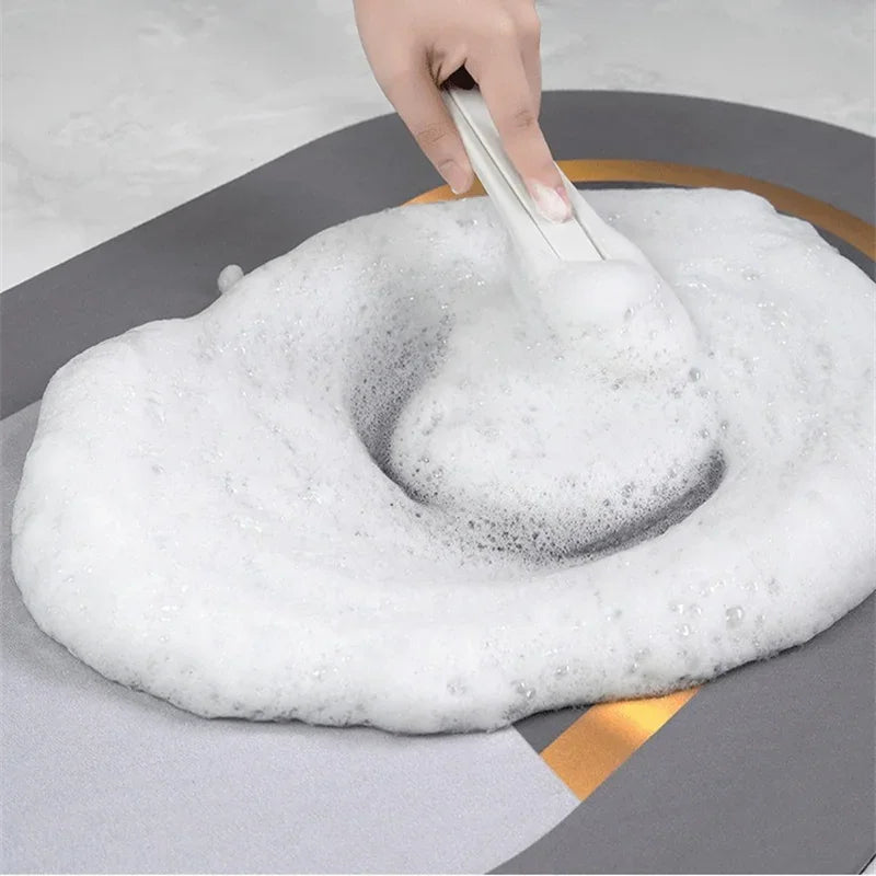 Cleaning an absorbent kitchen mat with soap foam and a brush.