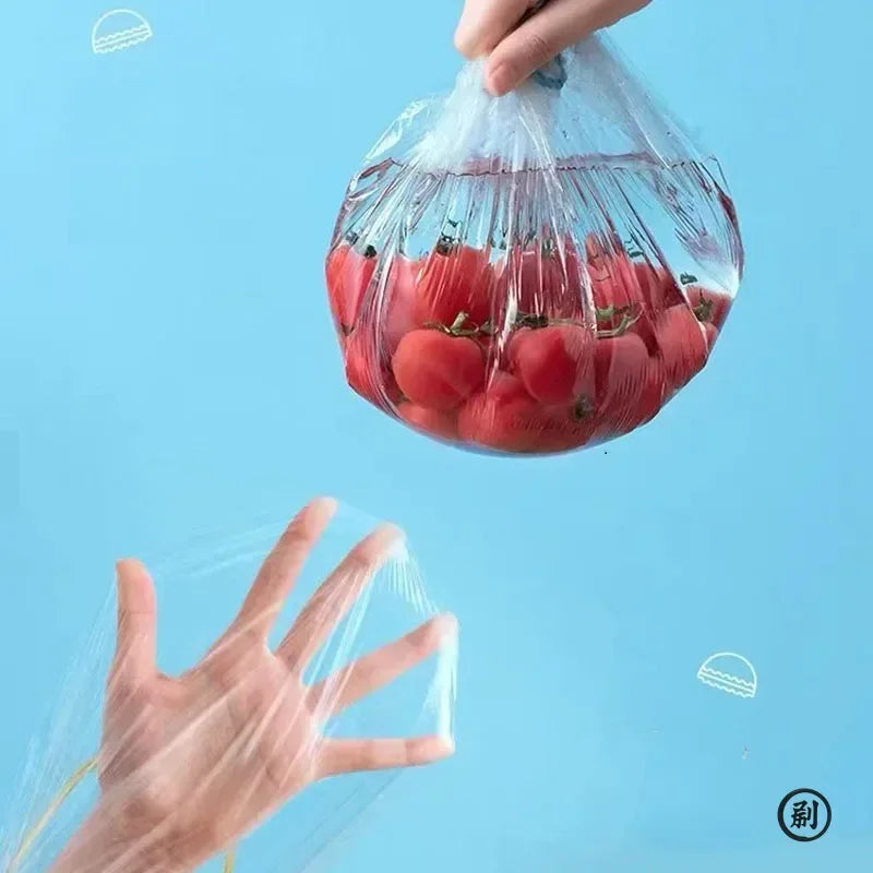 Hand holding an elastic plastic food cover bag filled with tomatoes