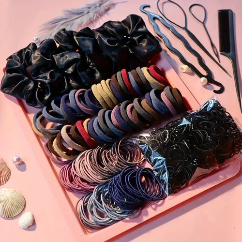 Hair accessory set with scrunchies, elastic bands, plastic styling tools, and a hair comb on a pink tray.