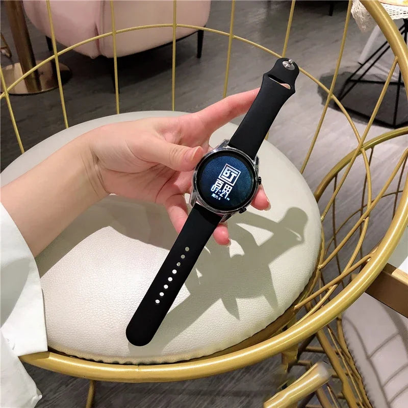 Person wearing a black silicone smartwatch band.
