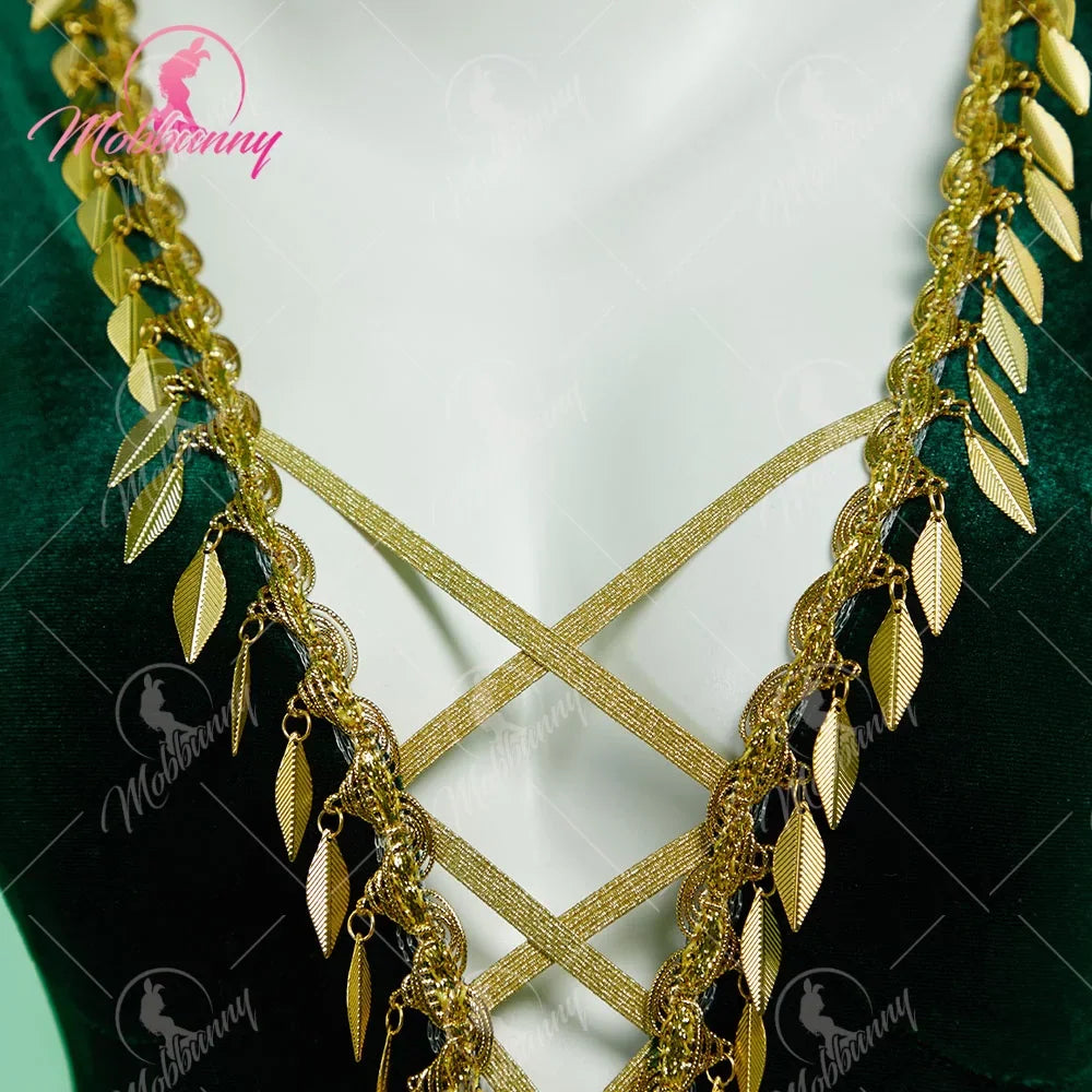 Close up of gold leaf trim and crisscross lacing on a green velvet bodysuit