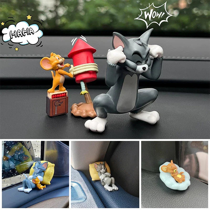Small cartoon cat and mouse figurines displayed on a car dashboard